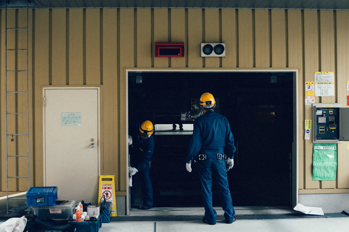 Technicians working at an open overhead door